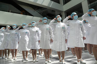 Nurses take part in an event held to mark the International Nurses Day in Wuhan