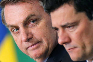 FILE PHOTO: Brazil's President Jair Bolsonaro and Brazil's Justice Minister Sergio Moro attend a launch ceremony of the government anti-crime project at the Planalto Palace in Brasilia