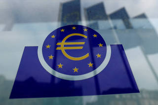 FILE PHOTO: Specialists work on a crane in front of the European Central Bank (ECB) in Frankfurt