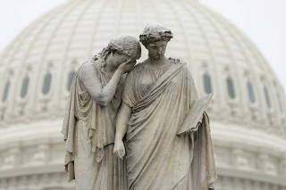 FILE PHOTO: Statue at the U.S. Capitol as the Senate debates a Coronavirus stimulus bill in Washington