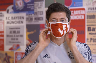 FC Bayern Munich player Robert Lewandowski shows importance of wearing a face mask to prevent the spread of the coronavirus disease (COVID-19)