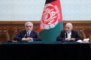 Afghanistan's President Ashraf Ghani and his rival Abdullah Abdullah sign agreement in Kabul