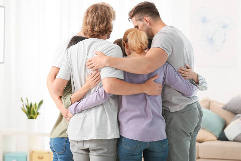 People hugging at group therapy session