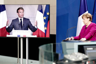 FILE PHOTO: German Chancellor Angela Merkel holds a joint video news conference with French President Emmanuel Macron