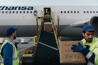 A Lufthansa flight is loaded with cargo as ticket sales are down during the coronavirus pandemic, at Frankfurt Airport in Germany, April 20, 2020. (Felix Schmitt/The New York Times)