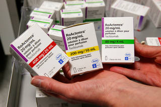 A pharmacist displays boxes of tocilizumab at the pharmacy of Cambrai hospital