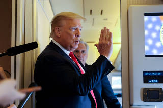 U.S. President Trump speaks to reporters aboard Air Force One while returning to Washington  from Cape Canaveral, Florida