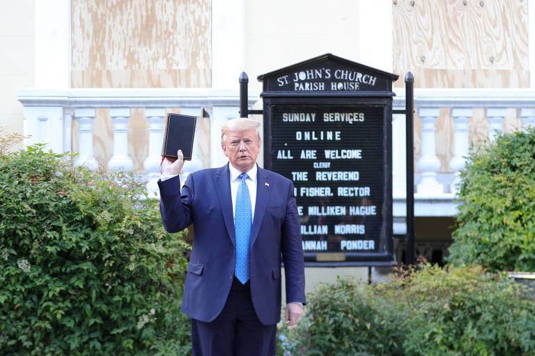 Segurando uma Bíblia, Trump posa para fotos em frente à igreja de St. John, a poucos metros da Casa Branca, em Washington

