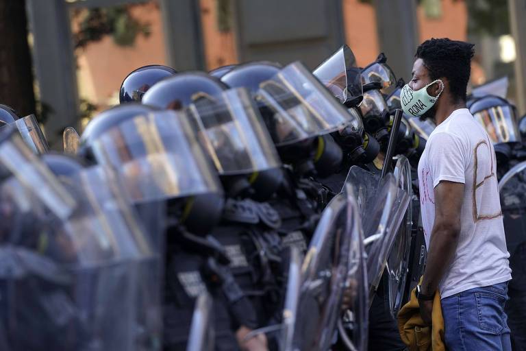 Manifestante encara policiais durante protesto no dia 1º de junho, em Washington D.C