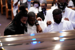 Mourners pause by the casket of George Floyd during a funeral service