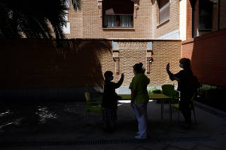 Angela Navas bids farewell to her sister Manuela Navas on the first day family visits are resumed after three months amid the coronavirus disease (COVID-19) outbreak at the nursing home Centro Casaverde in Navalcarnero