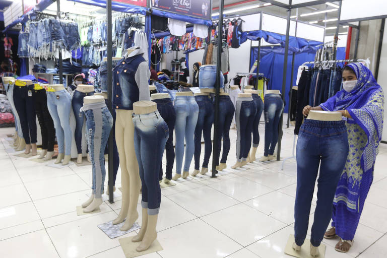 Após 83 dias sem abrir, shoppings puderam abrir com horário reduzido, das 6h às 10h ou das 16h às 20h. Na foto, comerciante organiza sua loja no Shopping Azulão, no Brás.