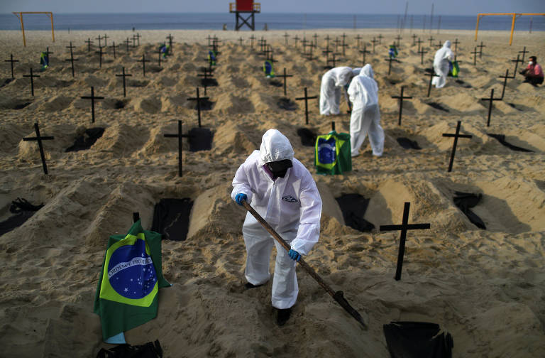 ONG Rio de Paz abre covas na praia de Copacabana para marcar as mortes causadas pelo coronavírus