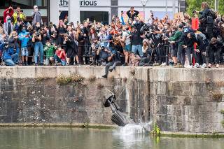 FILE PHOTO: The statue of Edward Colston falls into the water after protesters pulled it down in Bristol