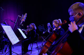 Musicians of the Ukrainian Radio Symphony Orchestra take part in a rehearsal after an easing of lockdown measures in Kiev