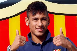 FILE PHOTO: Brazilian forward Neymar poses for photographs after completing his transfer from Santos to Barcelona in 2013 for 48.6 million euros ($54.01 million).