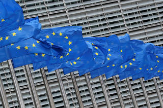 European Union flags flutter outside the European Commission headquarters in Brussels