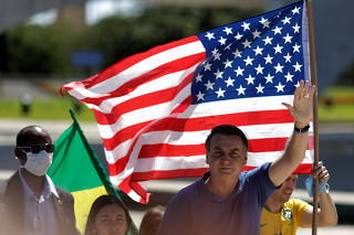 Brazil's President Jair Bolsonaro greets supporters during a protest, in Brasilia