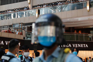 Riot police patrol at a shopping mall during a protest after China's parliament passes national security law for Hong Kong, in Hong Kong