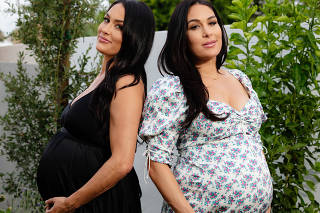 From left, Nikki and Brie Bella, at home in Phoenix, June 24, 2020. (Cassidy Araiza/The New York Times)