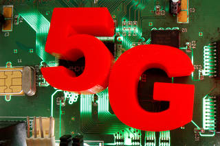 FILE PHOTO: 3D-printed objects representing 5G are put on a motherboard in this picture illustration