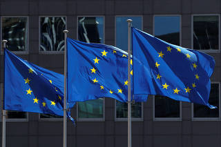 FILE PHOTO: European Union flags flutter outside the European Commission headquarters in Brussels
