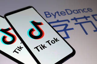 FILE PHOTO: TikTok logos are seen on smartphones in front of displayed ByteDance logo in this illustration