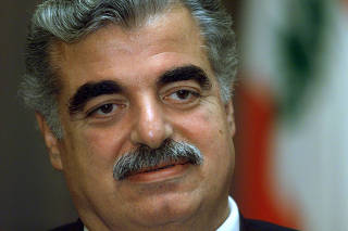 FILE PHOTO: Lebanese Prime Minister Rafik al-Hariri speaks during an interview with Reuters at his home in Beirut