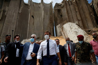 FILE PHOTO: French President Emmanuel Macron  gestures as he visits the devastated site of the explosion at the port of Beirut