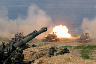 FILE PHOTO: A CM-11 Brave Tiger tank fires during the live fire Han Kuang military exercise, which simulates China's People's Liberation Army (PLA) invading the island, in Pingtung