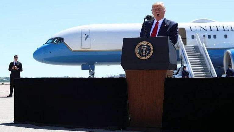 Trump discursa em pódio montado em pista de pouso de avião