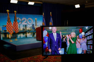 Democratic 2020 presidential nominee and former Vice President Joe Biden is seen in a video feed from Delaware being applauded by his wife Jill and his grandchildren after winning the Democratic Party?s 2020 presidential nomination in Wisconsin