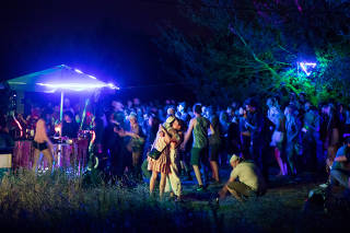 A party on the northeastern outskirts of Berlin, Aug. 1, 2020. (Gordon Welters/The New York Times)