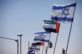 FILE PHOTO: The national flags of Israel and the United Arab Emirates flutter along a highway following the agreement to formalize ties between the two countries, in Netanya