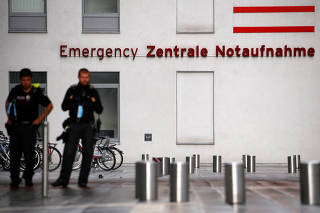 Police officers stand outside the Charite Mitte Hospital Complex in Berlin
