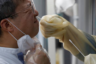 A man undergoes a coronavirus disease (COVID-19) test at a makeshift clinic in Seoul