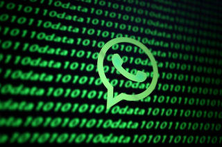 FILE PHOTO: The Whatsapp logo and binary cyber codes are seen in this illustration