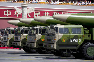FILE PHOTO:  Military vehicles carrying DF-26 ballistic missiles travel past Tiananmen Gate during a military parade to commemorate the 70th anniversary of the end of World War II in Beijing