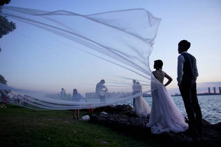 The Wider Image: Coronavirus dampens celebrations in China's wedding gown city
