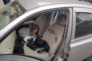 Bloodstains and equpment are seen in a car of Armenian reporters, after it was damaged during a recent shelling, in the town of Martuni in the breakaway region of Nagorno-Karabakh