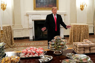 U.S. President Donald Trump speaks in front of fast food provided for the 2018 College Football Playoff National Champion Clemson Tigers due to the partial government shutdown in the State Dining Room of the White House in Washington