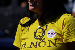 A supporter of U.S. President Donald Trump wears a QAnon shirt after participating in a caravan convoy circuit in Adairsville