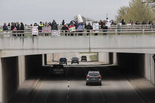 Demonstrators protest cuts in pay, benefits and school funding near the Oklahoma State Capitol in Oklahoma City
