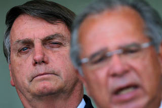 Brazil's President Jair Bolsonaro and Economy Minister Paulo Guedes attend a press statement at the Alvorada Palace in Brasilia