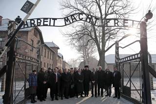 Israelian Minister of Immigrant Absorption Landver, the newly elected head of Israel's left-of-centre Labour Party Herzog and the director of Auschwitz Cywinski and members of the Knesset pose at the entrance of the former concentration camp in Auschwitz