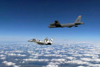 U.S. Air Force B-52 Stratofortress bomber, escorted by Ukrainian Air Force MiG-29 jet fighter, flies in Ukrainian airspace