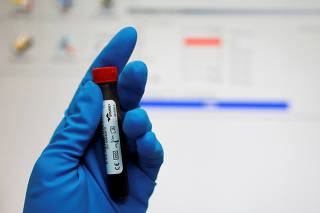 Technician holds test tube with blood sample at Russian anti-doping laboratory in Moscow