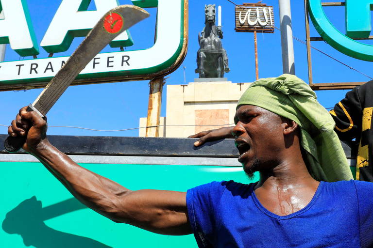 Somali brande facão em protesto contra o presidente Emmanuel Macron, em Mogadiscio