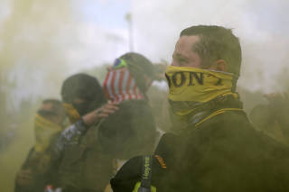 FILE PHOTO: Members of Proud Boys gather for a rally in Portland