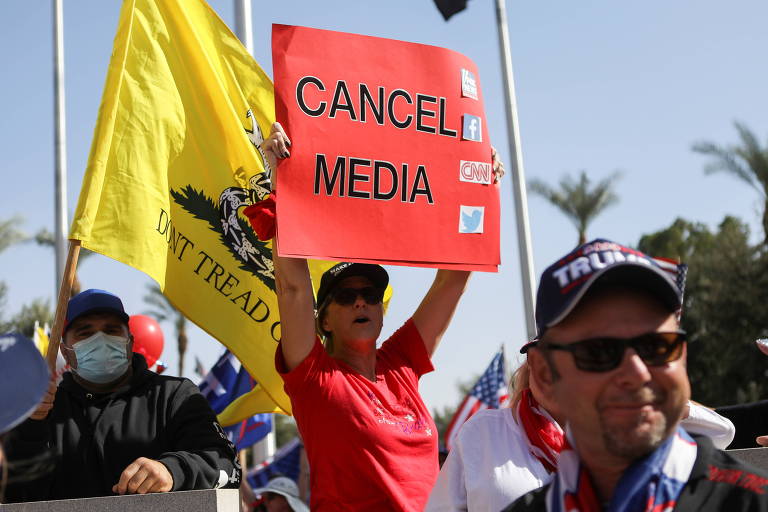 Cartaz protesta contra a mídia em ato em favor de Donald Trump em Phoenix, no Arizona